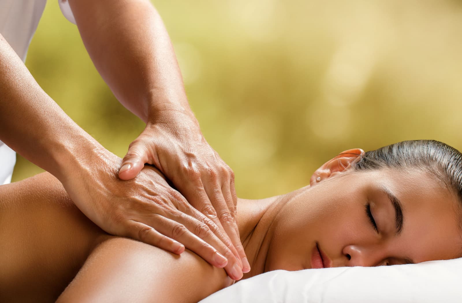 Skilled hands working on a client's back during a massage